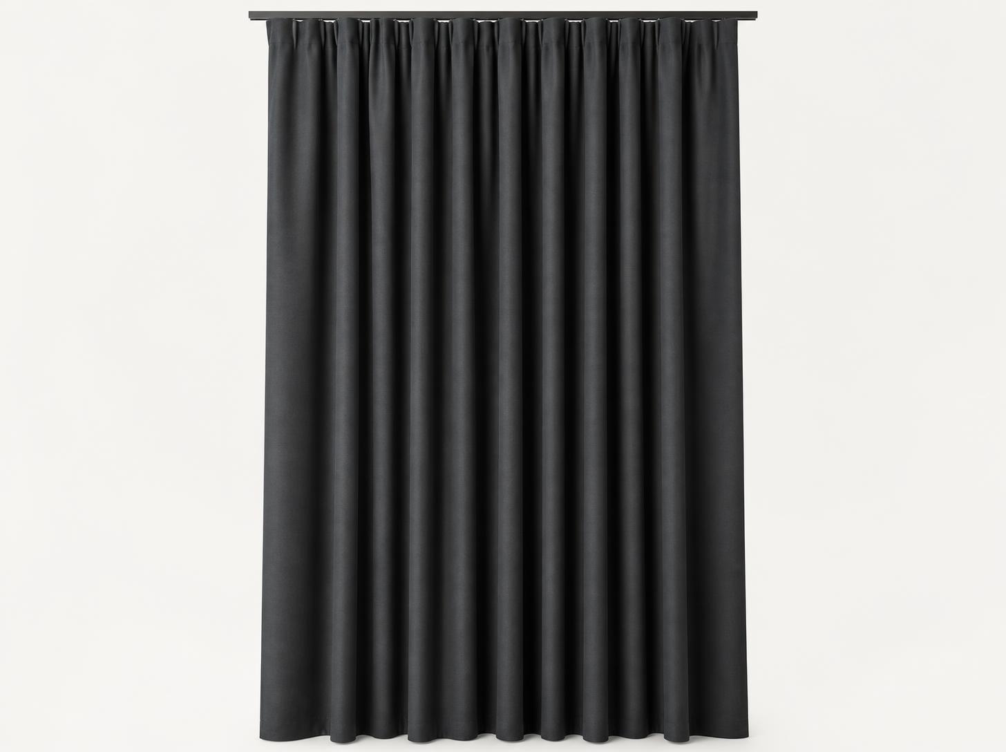 Pleated anthracite blackout curtain hung from a track