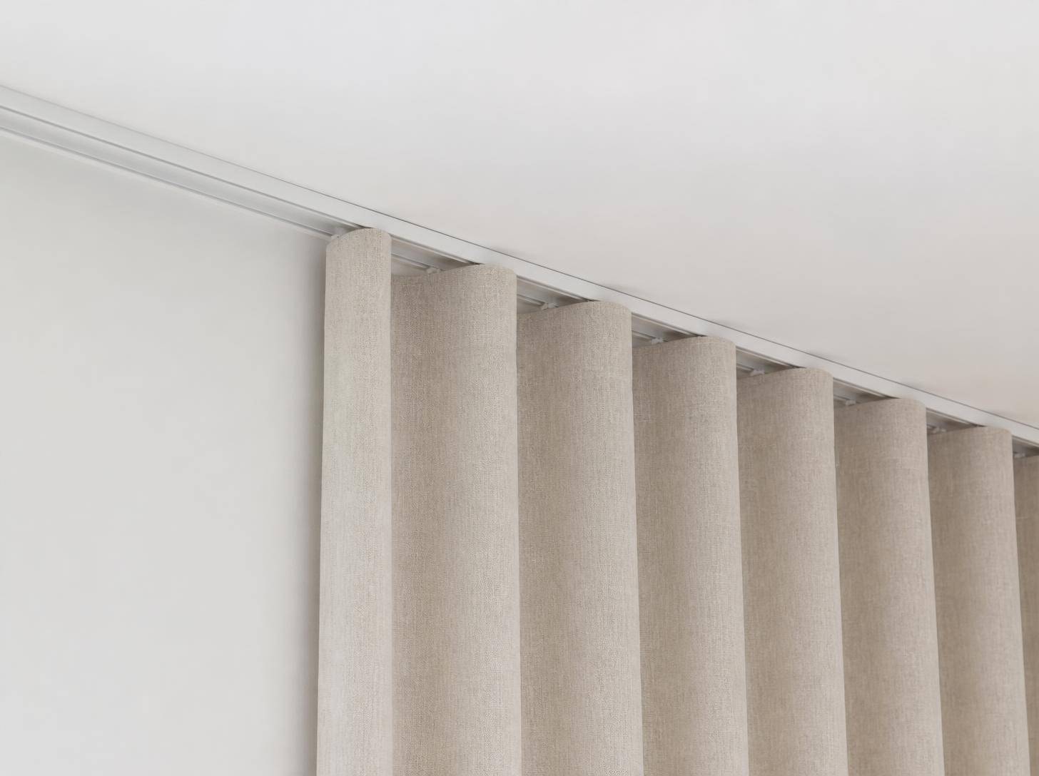 White curtain track fixed to the ceiling, beige curtain with a wave heading