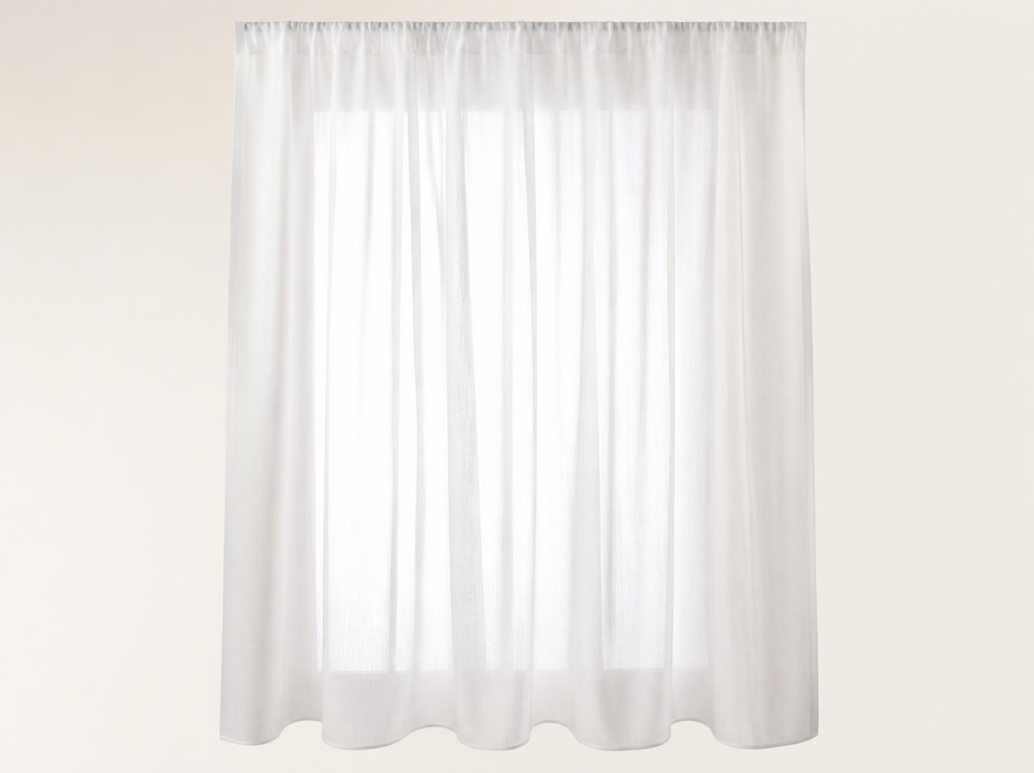 Translucent white sheer in front of a window, filtering daylight